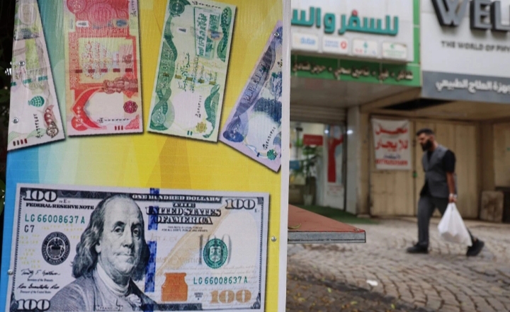 تخفيض الدينار العراقي   بنحو 15% مقابل الدولار
